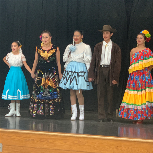 Members of the Latin Heritage Dance Company standing on stage